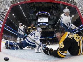 Bruins winger David Pastrnak ends up in the crease after scoring on Maple Leafs goaltender Garret Sparks on Saturday in Boston. (Winslow Townson/The Associated Press)