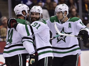 Dallas Stars’ Jamie Benn (left) celebrates his goal against hte Maple Leafs in Toronto on Thursday night with teammates Tyler Seguin (centre) and Jason Spezza. Spezza played his 1,000th NHL game this week and says he doesn’t sweat the financial issues any more and simply plays for the love of the game. (FRANK GUNN/THE CANADIAN PRESS)