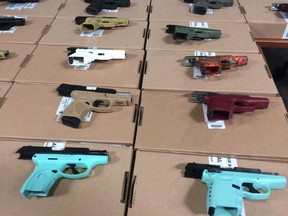 Firearms seized in raids on display at Toronto Police Headquarters on June 22, 2018. (Peter Goffin/The Canadian Press)