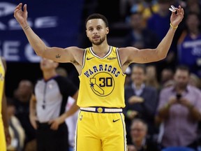 Warriors' Stephen Curry  reacts to the crowd chanting "MVP" during their game against the Wizards at ORACLE Arena in Oakland, Calif., on Oct. 24, 2018.