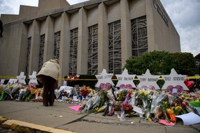 Mourners visit the memorial outside the Tree of Life Synagogue on October 31, 2018 in Pittsburgh, Pennsylvania, four days after 11 people were killed in a mass shooting. (Photo by Jeff Swensen/Getty Images)