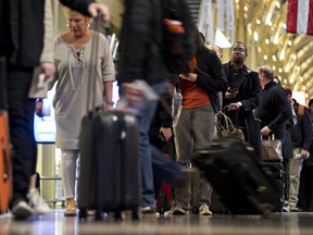 Travellers wait in line at Ronald Reagan National Airport in Washington on Nov. 22, 2017. (Bloomberg photo by Andrew Harrer)