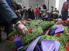 A thousand people braved frigid weather to attend the Remembrance Day Service at the Old City Hall Cenotaph in downtown Toronto on Saturday November 11, 2017. (Stan Behal/Toronto Sun)