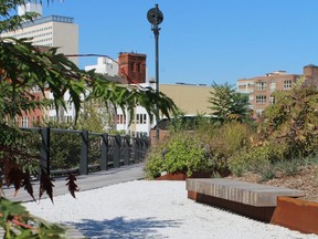 Planters lush with trees and flowers bring a touch of nature to the Philadelphia Rail Park, the first phase of which opened in June. Bountiful landscaping softens the hardscape and industrial feel of the converted railroad viaduct. (Scott Pruden for The Washington Post)