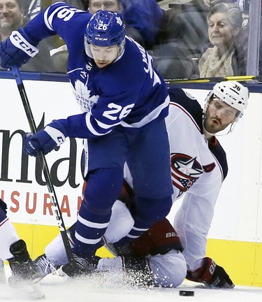 Toronto Maple Leafs center Par Lindholm (26 and Columbus Blue Jackets center Boone Jenner (38) battle for the puck during the first period on Monday November 19, 2018. The Toronto Maple Leafs host the Columbus Blue Jackets at the Scotiabank Arena in Toronto, On. Veronica Henri/Toronto Sun/Postmedia Network
