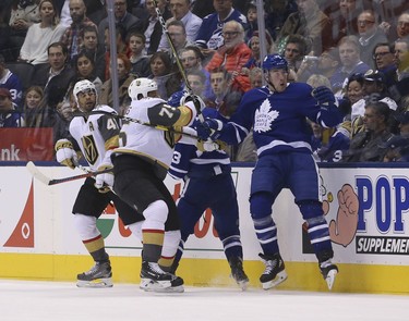 Vegas Golden Knights William Karlsson C (71) thumps Toronto Maple Leafs Frederik Gauthier C (33) into the boards during the first period in Toronto on Wednesday November 7, 2018. Jack Boland/Toronto Sun/Postmedia Network