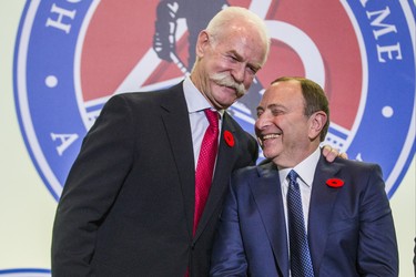 Lanny McDonald (left), Chairman of the Hockey Hall of Fame, shares a moment on the stage with 2018 Hockey Hall of Fame inductee Gary Bettman, during a presentation at the Hockey Hall of Fame in Toronto, Ont. on Friday November 9, 2018.. Ernest Doroszuk/Toronto Sun/Postmedia