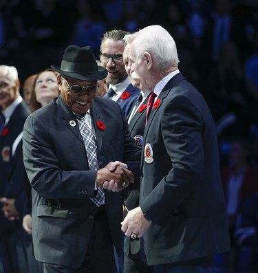 Hockey Hall of Fame inductee Willie O'Ree comes out to be greeted by alumni Lanny MacDonald in Toronto on Friday November 9, 2018. Jack Boland/Toronto Sun/Postmedia Network