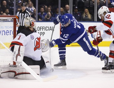 Toronto Maple Leafs Patrick Marleau C (12) tries to jam the puck past New Jersey Devils Keith Kinkaid G (1) during the first period in Toronto on Friday November 9, 2018. Jack Boland/Toronto Sun/Postmedia Network