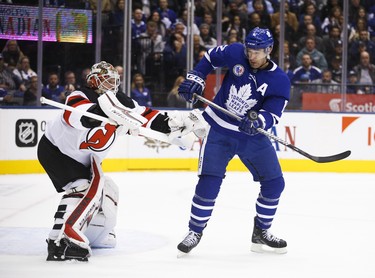 Toronto Maple Leafs Patrick Marleau C (12) tries to bat the puck in off his gloves in front of New Jersey Devils Keith Kinkaid G (1) during the first period in Toronto on Friday November 9, 2018. Jack Boland/Toronto Sun/Postmedia Network