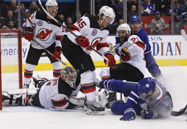 Toronto Maple Leafs Zach Hyman C (11) looks to score on New Jersey Devils Keith Kinkaid G (1) during a goal-mouth scramble during the first period in Toronto on Friday November 9, 2018. Jack Boland/Toronto Sun/Postmedia Network