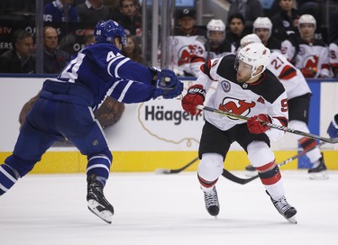 New Jersey Devils Taylor Hall LW (9) goes around Toronto Maple Leafs Zach Hyman C (11) during the second period in Toronto on Friday November 9, 2018. Jack Boland/Toronto Sun/Postmedia Network