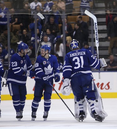 Toronto Maple Leafs Travis Dermott D (23), Andreas Johnsson LW (18) and Frederik Andersen G (31) celebrate the 6-1 win over the New Jersey Devils  in Toronto on Friday November 9, 2018. Jack Boland/Toronto Sun/Postmedia Network