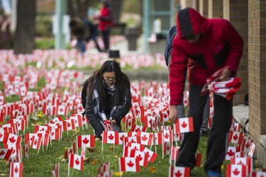 Volunteers place 47,500 Canadian flags on the lawns outside of Sunnybrook Veterans Centre on the grounds at Sunnybrook Health Sciences Centre in Toronto, Ont. on Saturday November 10, 2018. There were 100 flags for each of the 475 veterans that live there. Ernest Doroszuk/Toronto Sun/Postmedia