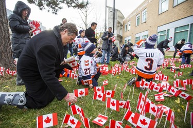 Toronto Mayor John Tory places several of the 47,500 Canadian flags on the lawns outside of Sunnybrook Veterans Centre on the grounds at Sunnybrook Health Sciences Centre in Toronto, Ont. on Saturday November 10, 2018. There were 100 flags for each of the 475 veterans that live there. Ernest Doroszuk/Toronto Sun/Postmedia
