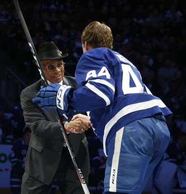 Hockey Hall of Fame inductee Willie O'Ree is congratulated by Toronto Maple Leafs Morgan Rielly  in Toronto on Friday November 9, 2018. Jack Boland/Toronto Sun/Postmedia Network