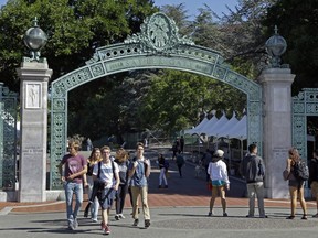 In this April 21, 2017, file photo, students walk past Sather Gate on the University of California, Berkeley campus in Berkeley, Calif.  (AP Photo/Ben Margot, File)