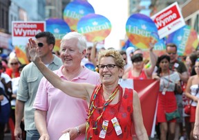 Ontario Premier Kathleen Wynne waves to supporters during the WorldPride Parade in Toronto, Sunday June 29, 2014. (THE CANADIAN PRESS/Kevin Van Paassen)