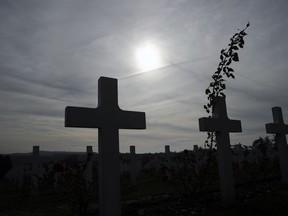 Graves are silhouetted at the cemetery by the Ossuary of Douaumont near Verdun, northeastern France, Tuesday, Nov. 6, 2018 during ceremonies marking the centenary of World War I globe.
