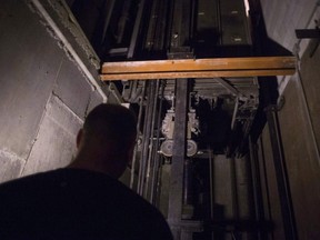 A building manager is pictured in an elevator shaft in a downtown Toronto office building on Wednesday, July 13, 2016. A report on elevator availability in Ontario is expected to be released on Thursday, along with the government's comprehensive plan to address all 19 recommendations in the study.THE CANADIAN PRESS/Chris Young ORG XMIT: CPT114