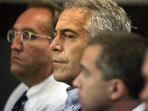 This July 30, 2008 photo shows Jeffrey Epstein in custody in West Palm Beach, Fla. Epstein was suspected nearly a decade ago of paying for sex with underage girls. The FBI abruptly dropped its investigation a few years ago, and Epstein pleaded guilty to a single state charge of soliciting prostitution. He served 13 months in jail. Now, two women who say they were sexually abused as girls by Epstein are hoping a trove of new documents will get the case reopened. (AP Photo)
