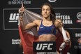 Joanna Jedrzejczyk poses on the scale during the weigh-in ahead of her flyweight bout against Valentina Shevchenko at UFC 231. (THE CANADIAN PRESS)