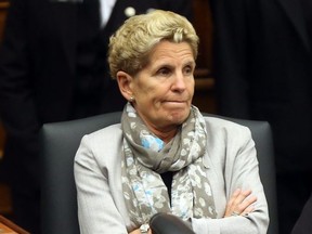 Kathleen Wynne listens to Premier Doug For after he announced his government will seek to create a select committee to investigate Liberal waste and scandal at Queen's Park in Toronto on September 24, 2018. Dave Abel/Toronto Sun