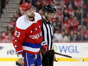 Tom Wilson of the Washington Capitals is escorted off the ice after his second-period hit  on Brent Seney of the New Jersey Devils at Capital One Arena on November 30, 2018 in Washington,. (Photo by Will Newton/Getty Images)