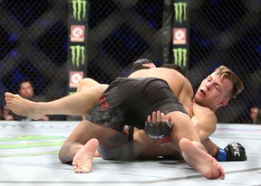 Brad Katona (bottom) of Canada fights against Matthew Lopez of the United States in a bantamweight bout during the UFC 231 event at Scotiabank Arena on Dec. 8, 2018 in Toronto.