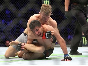 TORONTO, ON - DECEMBER 8:  Brad Katona (top) of Canada fights against Matthew Lopez of the United States in a bantamweight bout during the UFC 231 event at Scotiabank Arena on December 8, 2018 in Toronto, Canada.