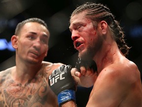 Max Holloway of the United States fights against Brian Ortega (R) of the United States in a featherweight bout during the UFC 231 event at Scotiabank Arena on December 8, 2018 in Toronto, Canada.