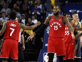 OAKLAND, CA - DECEMBER 12:  Greg Monroe #15 of the Toronto Raptors is congratulated by Kyle Lowry #7 after he was fouled by the Golden State Warriors at ORACLE Arena on December 12, 2018 in Oakland, California.  NOTE TO USER: User expressly acknowledges and agrees that, by downloading and or using this photograph, User is consenting to the terms and conditions of the Getty Images License Agreement.  (Photo by Ezra Shaw/Getty Images)