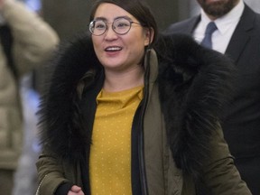 Law student and escort Nadia Guo leaves for a lunch break after appearing before a hearing of the Ontario Law Society on Dec. 13. (Stan Behal, Toronto Sun)