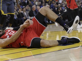 Toronto Raptors center Jonas Valanciunas reacts after injuring his hand on Wednesday night. (AP PHOTO)