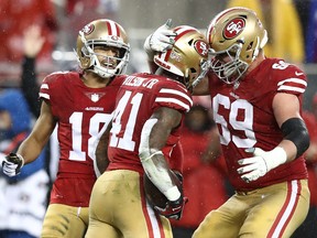Jeff Wilson (centre) of the San Francisco 49ers celebrates after a 16-yard run against the Seattle Seahawks in overtime on Sunday. (GETTY IMAGES)