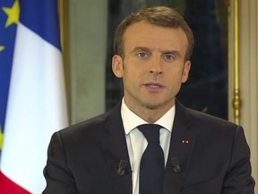 In this frame grab taken from video provided by French TV channel TF1, French President Emmanuel Macron addresses the nation during a live statement at the presidential palace in Paris, France, Monday, Dec. 10, 2018.  President Emmanuel Macron broke his silence Monday on the exceptional protests shaking France and his presidency, promising broad tax relief for struggling workers and pensioners — and acknowledging his own responsibility in fueling the nation's anger. (TF1 via AP)