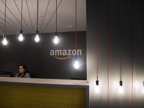 An employee works the front reception at the the new Amazon office in downtown Toronto on Tuesday, Dec. 18, 2018.