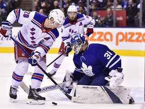 Leafs goaltender Frederik Andersen (right) stops New York Rangers forward Chris Kreider last night. (The Canadian Press)