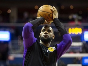 In this Dec. 16, 2018 file photo Los Angeles Lakers forward LeBron James warms up before an NBA game against the Washington Wizards in Washington.