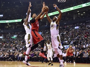 Indiana Pacers guard Victor Oladipo (4) and Indiana Pacers center Myles Turner (33) defend as Toronto Raptors forward Norman Powell (24) drives to the basket during first half NBA basketball action in Toronto on Wednesday, Dec. 19, 2018. THE CANADIAN PRESS/Frank Gunn ORG XMIT: FNG203