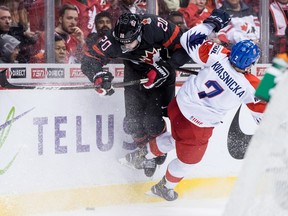 Canada's Brett Leason, left, and Czech Republic's David Kvasnicka collide during third period world junior hockey championship action in Vancouver, Saturday, Dec. 29, 2018.