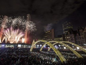 Fireworks explode during New Year's Eve celebrations at Nathan Phillips Square in Toronto.