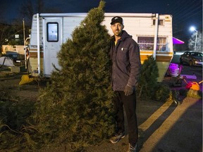 Josh Dorion, of Midland, Ont. poses with his last Christmas tree for sale in the lot of the Dairy Queen in Clarkson along Lakeshore Rd. W. in Missisauga, Ont. on Tuesday December 18, 2018. His family has been selling out of that lot since 1979 when his grandfather was selling trees. Ernest Doroszuk/Toronto Sun/Postmedia