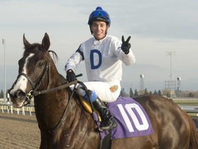 Jockey Luis Contreras, atop He’s a Macho Man, celebrates his 2,000th career victory at Woodbine Racetrack on Sunday. (Michael Burns/Photo)