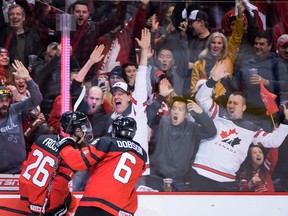 Canada's Morgan Frost (left) and Noah Dobson celebrate a goal by Frost against Denmark during first period IIHF world junior hockey championship action in Vancouver, on Wednesday, Dec.26, 2018. (DARRYL DYCK/THE CANADIAN PRESS)