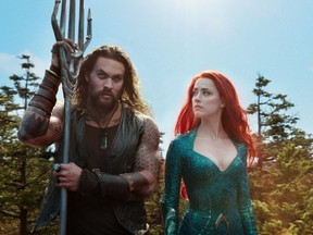 This image released by Warner Bros. Pictures shows Jason Momoa, left, and Amber Heard in a scene from "Aquaman."