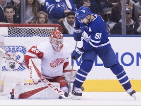 Toronto Maple Leafs John Tavares tries to tip the puck past Detroit Red Wings goaltender Jonathan Bernier during third period NHL hockey action in Toronto, on Sunday, December 23, 2018.THE CANADIAN PRESS/Chris Young