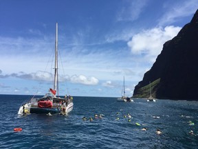 During a cruise along Kauai’s Napali Coast, catamarans stop to let passengers swim and snorkel.ROBIN ROBINSON