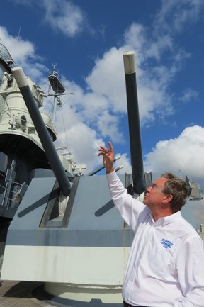 Capt. Terry Bragg (ret.), executive director of Battleship North Carolina, shows anti-aircraft guns on the deck of first U.S. Navy ‘state class’ battleship. (Ian S. Robertson)