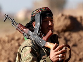 A member of the Syrian Democratic Forces (SDF) holding his rifle in Hajin, in the Deir Ezzor province, eastern Syria, on December 15, 2018.